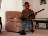 Backpacker killer Ivan Milat, whose murderous rampage partly inspired the movie Wolf Creek poses in his western Sydney living room.