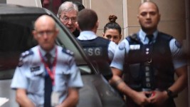 George Pell is led in to court. Picture: AAP
