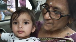 One-year-old Aishwarya Bhattacharya is held by her grandmother in a car shortly after her arrival at IGI airport in New Delhi, India, a year after Norwegian officials took her away.